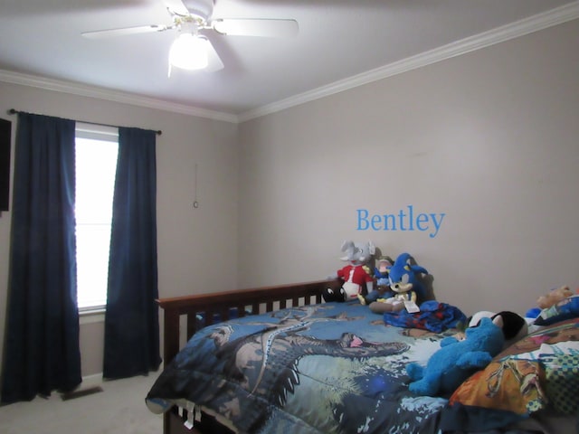 bedroom with ceiling fan, ornamental molding, and carpet floors