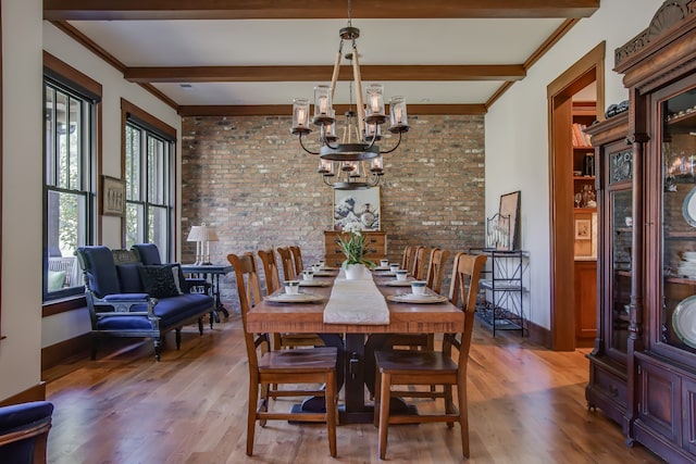 dining room with beam ceiling, brick wall, and hardwood / wood-style flooring