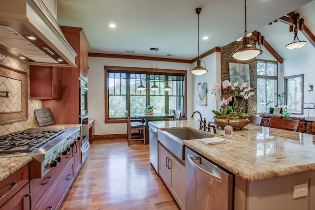 kitchen featuring custom exhaust hood, backsplash, a center island with sink, appliances with stainless steel finishes, and decorative light fixtures