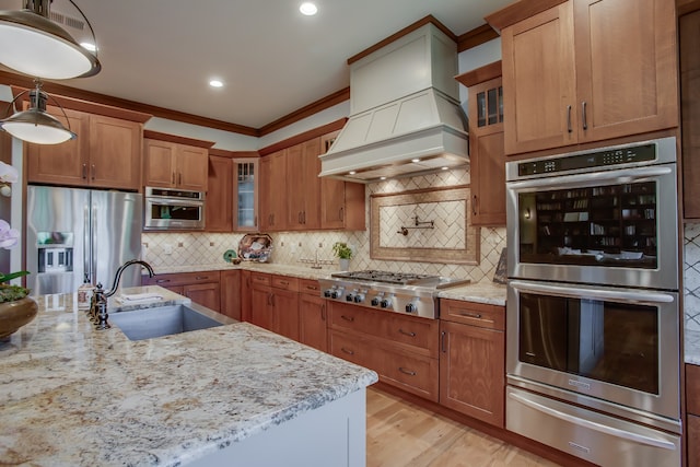 kitchen featuring decorative backsplash, ornamental molding, custom exhaust hood, stainless steel appliances, and sink