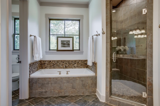 bathroom featuring plus walk in shower and toilet