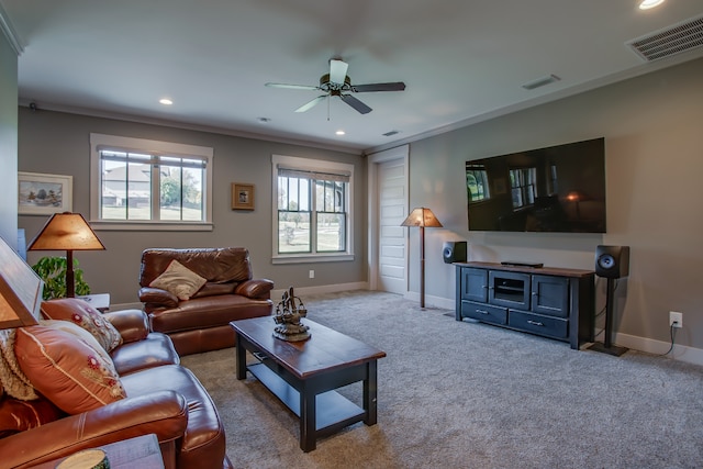 carpeted living room featuring ceiling fan and ornamental molding