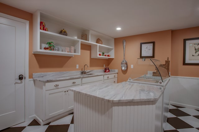 laundry area with cabinets, separate washer and dryer, and sink