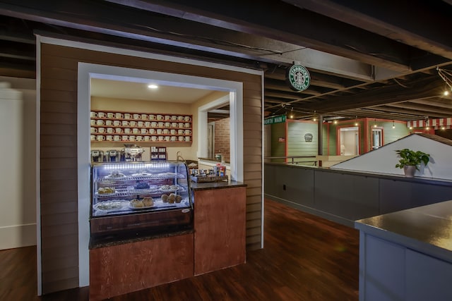 bar with wood walls and dark hardwood / wood-style floors