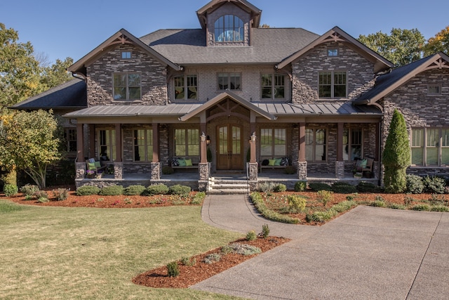 craftsman house with a porch and a front yard