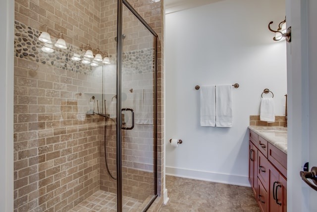 bathroom featuring a shower with door and vanity