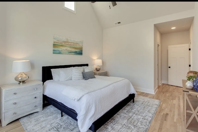 bedroom with vaulted ceiling, light hardwood / wood-style floors, and ceiling fan