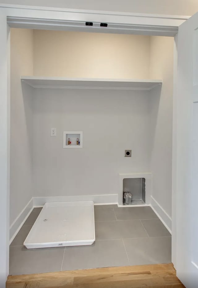 laundry room with hookup for an electric dryer, washer hookup, and tile patterned floors