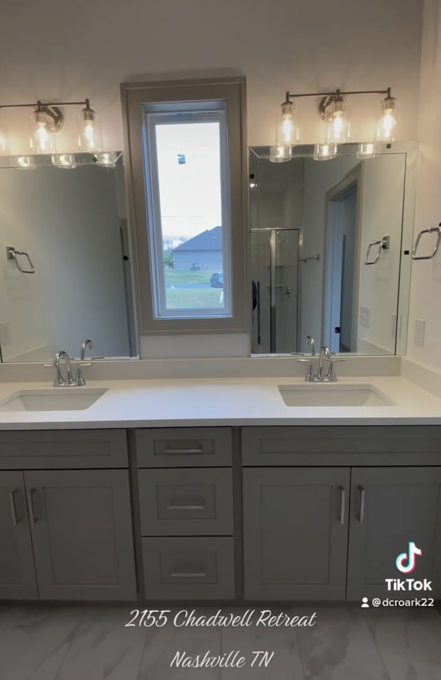 bathroom with a shower with door and vanity