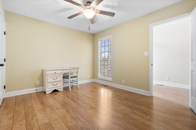 spare room with light hardwood / wood-style floors and ceiling fan