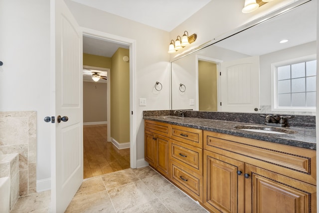 bathroom featuring vanity, hardwood / wood-style flooring, and ceiling fan