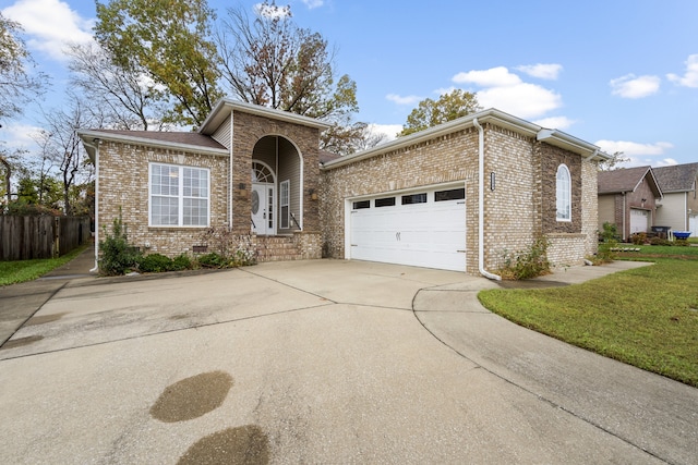 view of front of house with a garage and a front yard