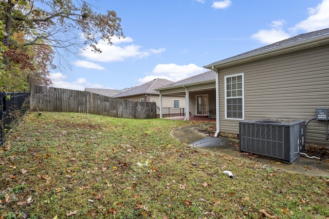 view of yard with central AC and a patio area