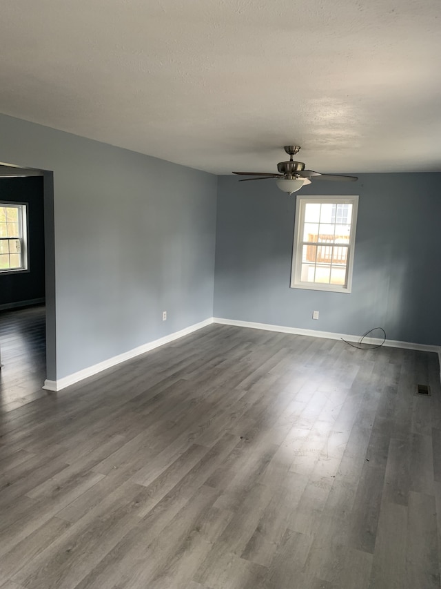 unfurnished room with hardwood / wood-style floors, a textured ceiling, and ceiling fan