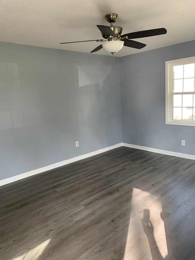 spare room featuring ceiling fan and dark hardwood / wood-style flooring