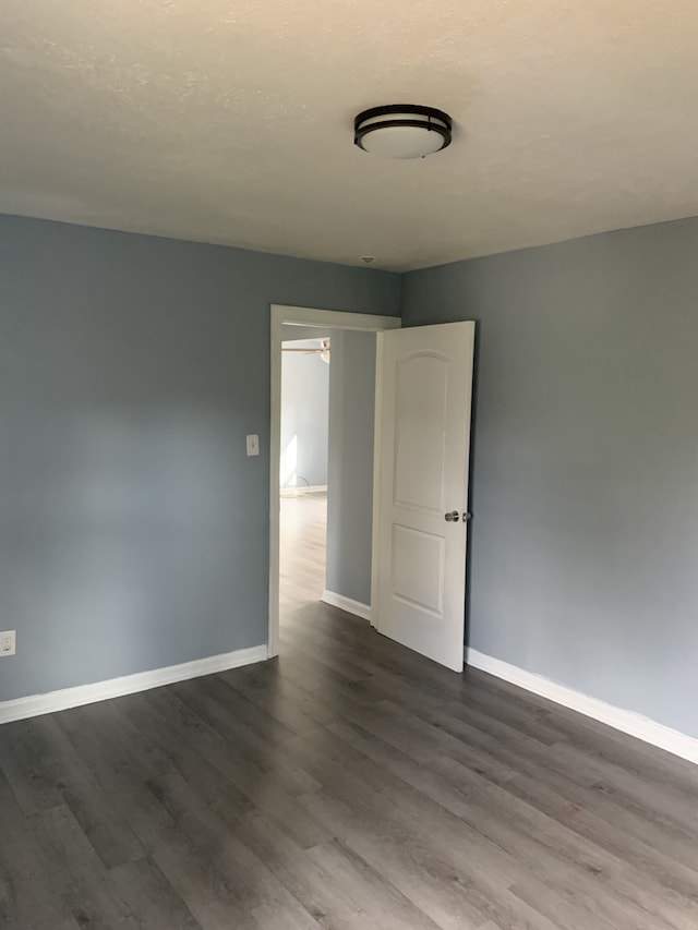 unfurnished room featuring dark hardwood / wood-style floors