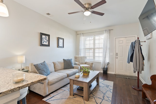 living room with dark wood-type flooring and ceiling fan