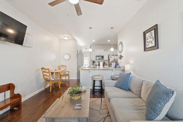 living room featuring dark hardwood / wood-style flooring and ceiling fan