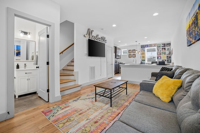 living room featuring light hardwood / wood-style floors and sink