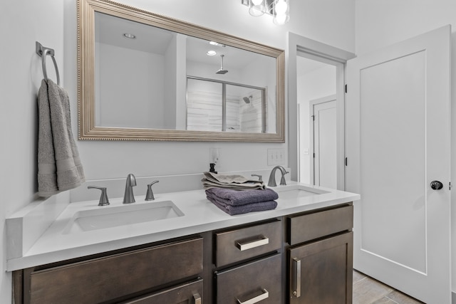 bathroom with vanity, wood-type flooring, and a shower with shower door