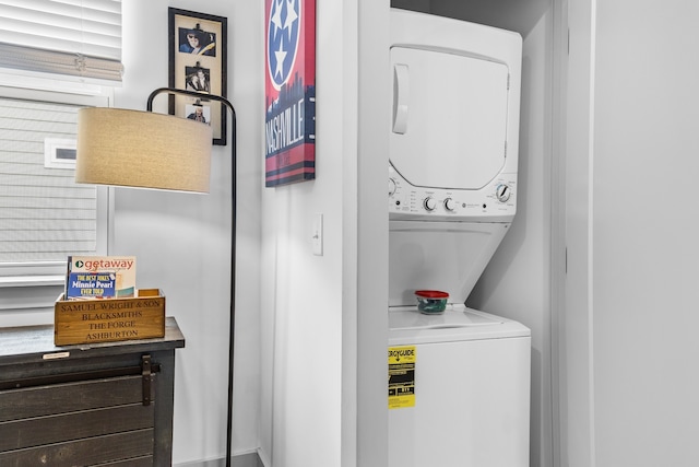 clothes washing area with stacked washer and dryer