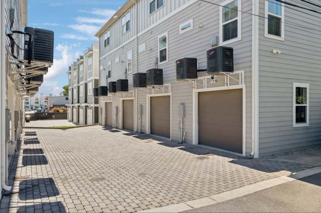 exterior space featuring central AC unit and a garage