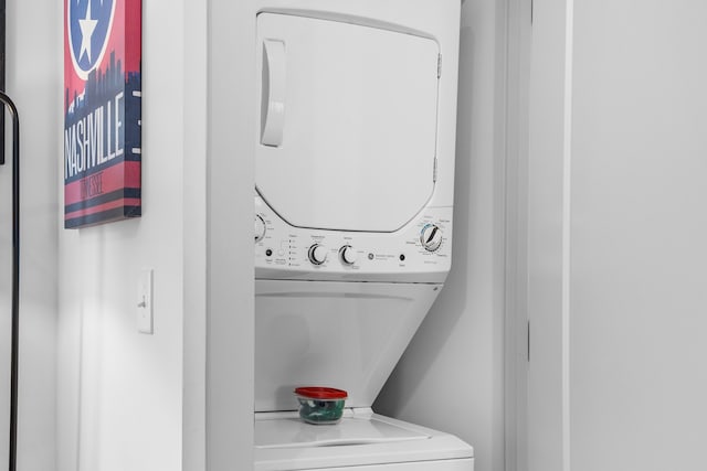 laundry area featuring stacked washer / dryer