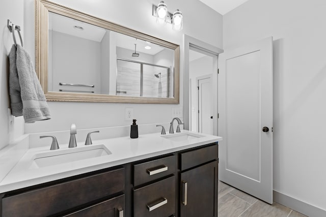 bathroom featuring vanity and a shower with shower door