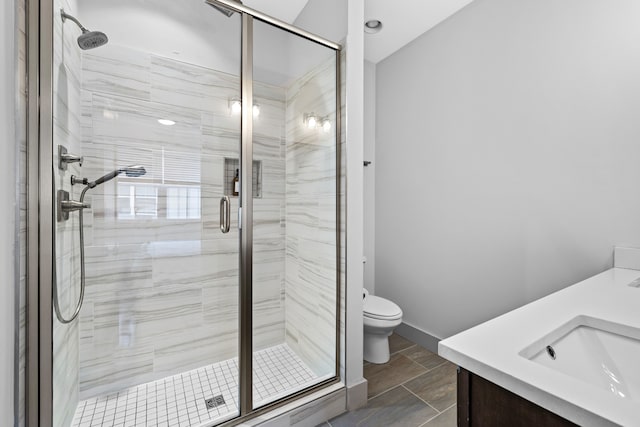 bathroom with vanity, toilet, and walk in shower