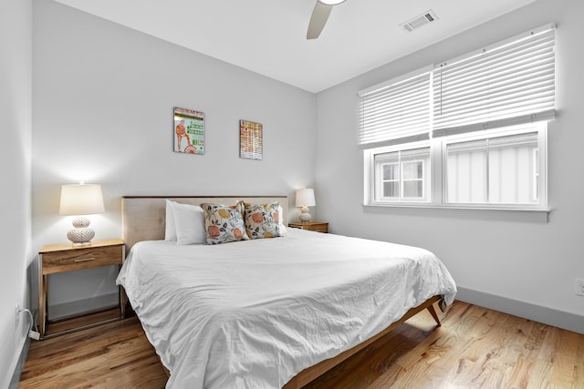 bedroom with wood-type flooring and ceiling fan