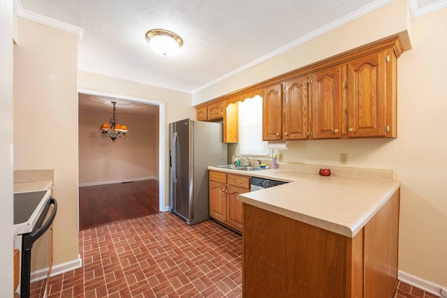 kitchen with appliances with stainless steel finishes, sink, an inviting chandelier, and ornamental molding