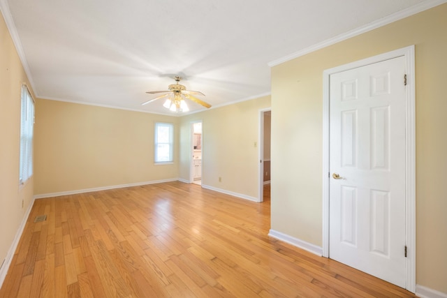 empty room with light hardwood / wood-style floors, ornamental molding, and ceiling fan