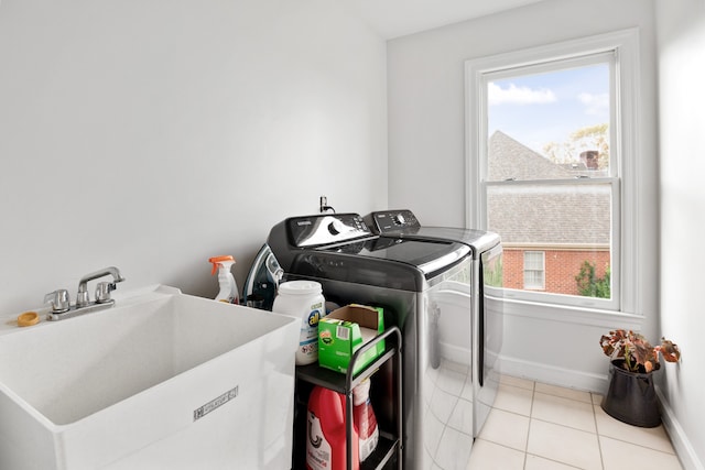 washroom with separate washer and dryer, plenty of natural light, sink, and light tile patterned floors