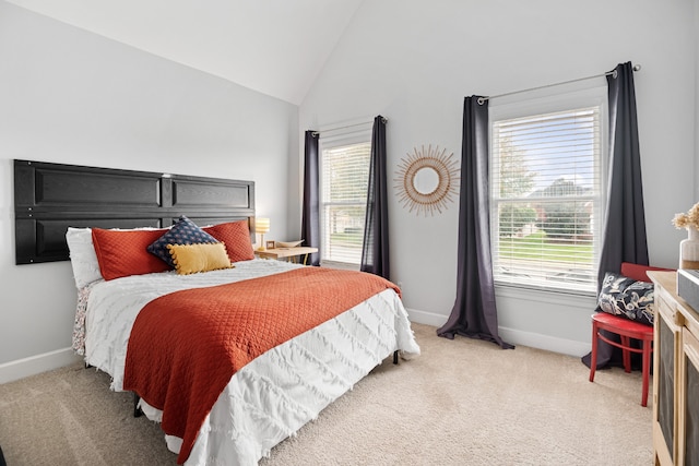 carpeted bedroom with lofted ceiling