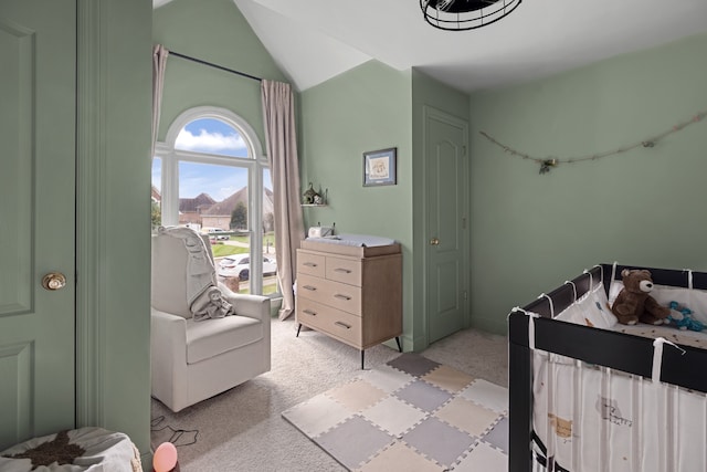 carpeted bedroom with lofted ceiling