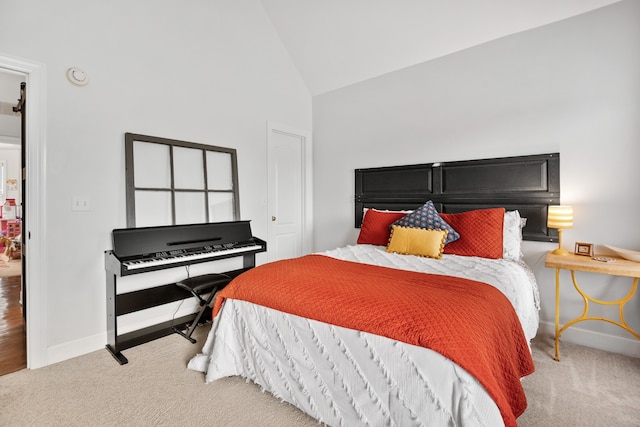 carpeted bedroom with high vaulted ceiling