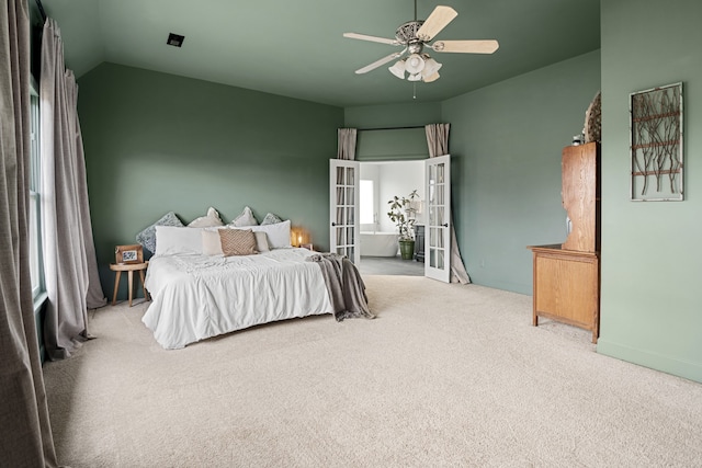 bedroom with lofted ceiling, light colored carpet, and ceiling fan