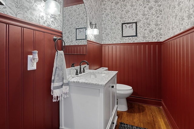 bathroom featuring hardwood / wood-style floors, vanity, and toilet