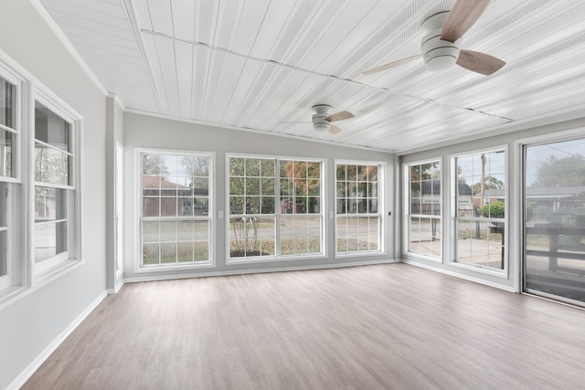 unfurnished sunroom with vaulted ceiling and ceiling fan