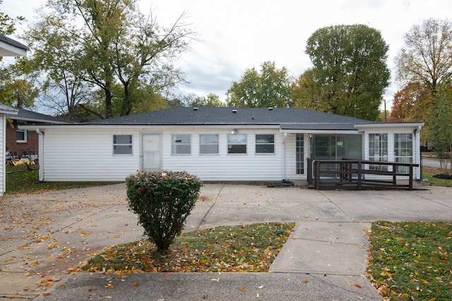 back of house with a deck