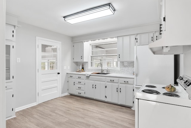 kitchen featuring white appliances, sink, light wood-type flooring, backsplash, and white cabinetry