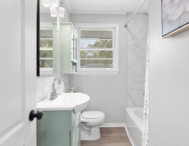 full bathroom featuring ornamental molding, hardwood / wood-style floors, toilet, vanity, and shower / bathtub combination with curtain