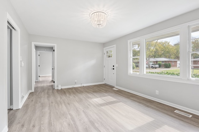 empty room featuring light hardwood / wood-style floors and a healthy amount of sunlight