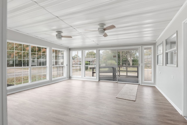 unfurnished sunroom with ceiling fan