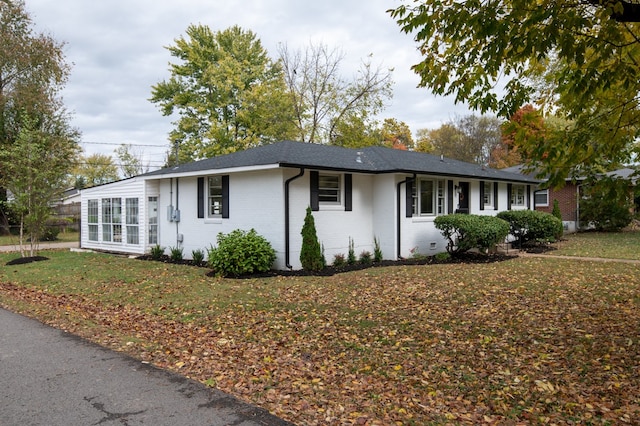 ranch-style house with a front lawn