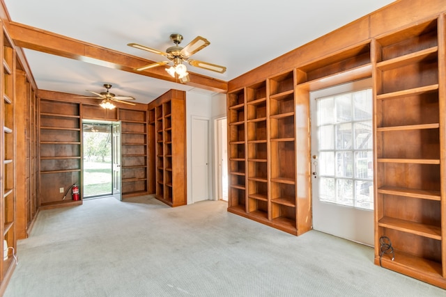 interior space featuring light colored carpet, a wealth of natural light, and ceiling fan