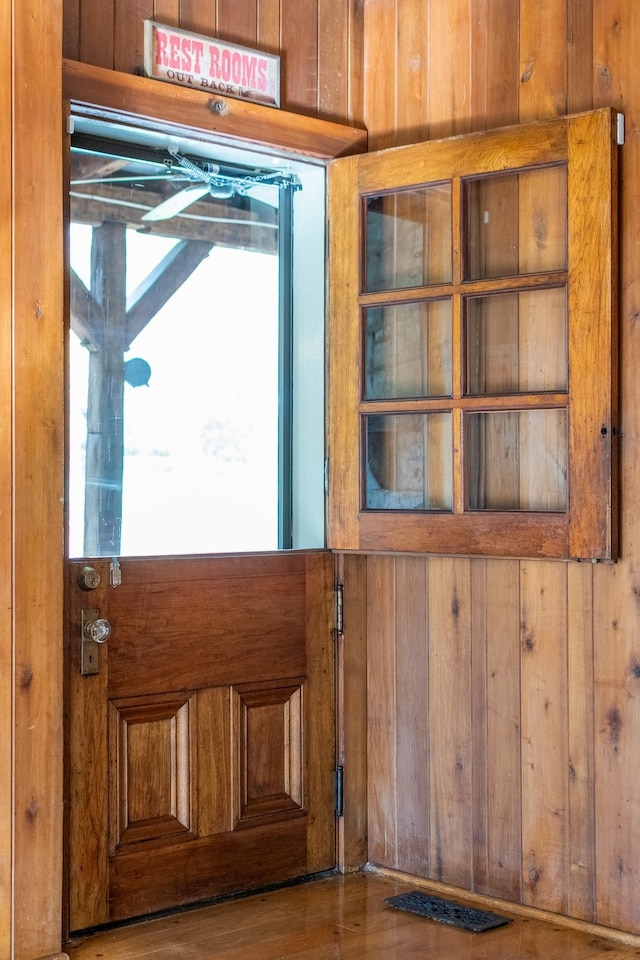 interior details featuring wooden walls and wood-type flooring