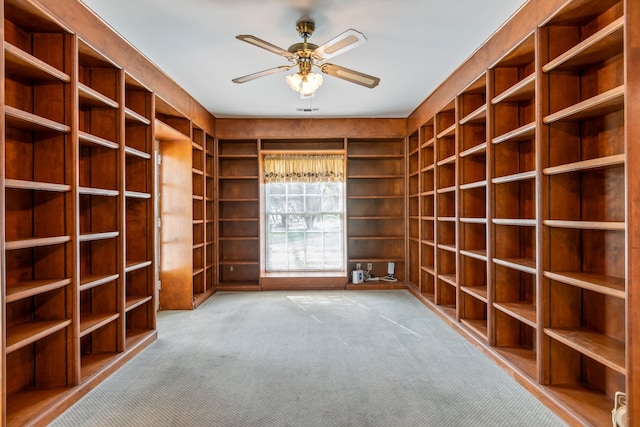 wine cellar with light carpet and ceiling fan