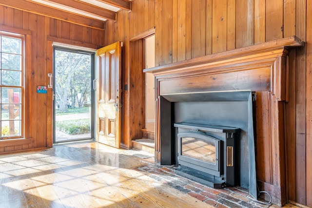 interior space with a wood stove and wood walls