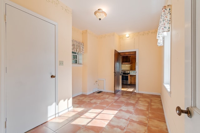 hallway with tile patterned flooring